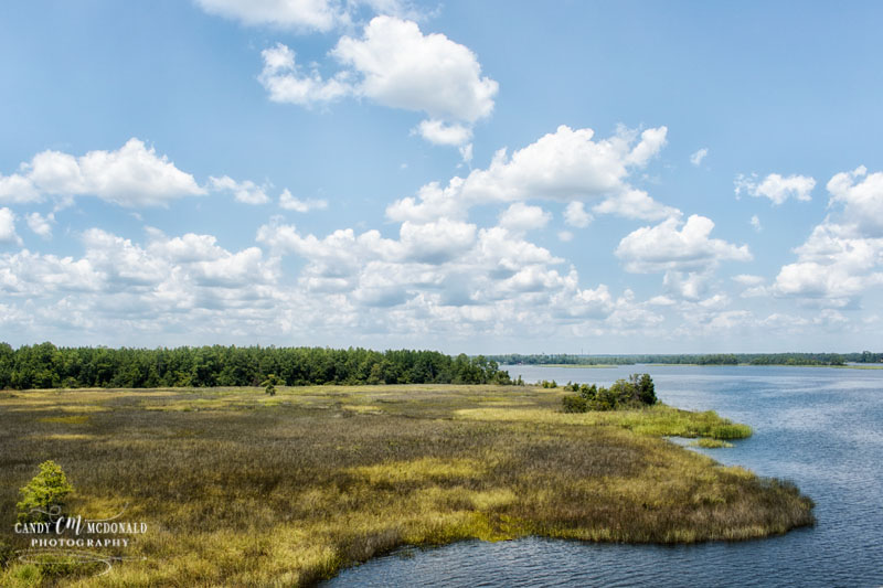 View of Blackwater River and its surrounding marsh with blue skies and some clouds as seen from I-10 west in Florida.