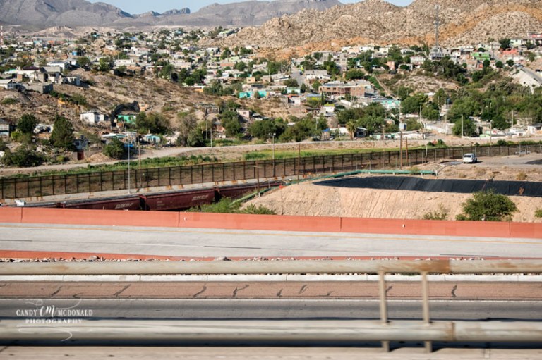 The US/Mexico border fence line in El Paso, Texas as seen from westbound I-10