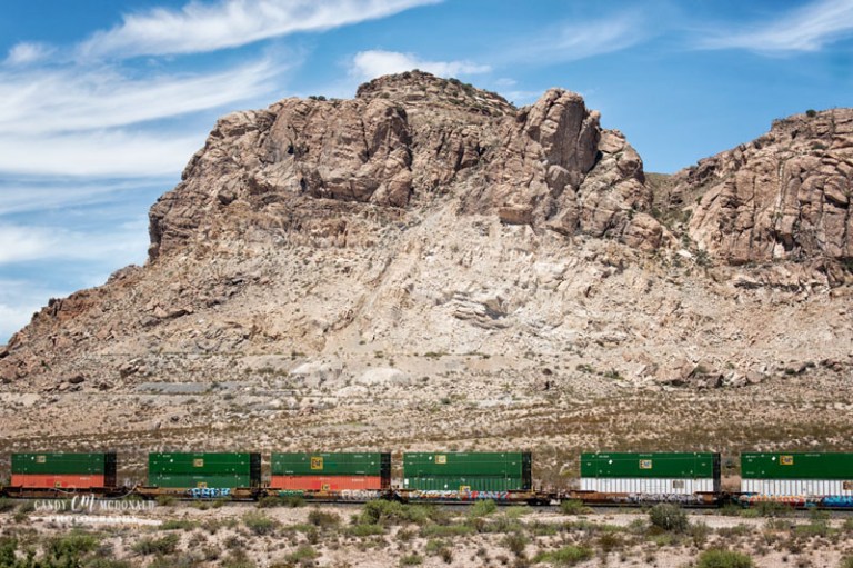Train running through the desert of NM
